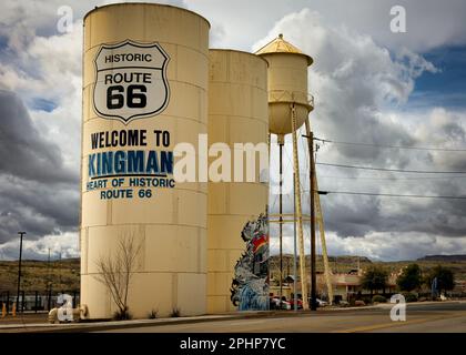 Storm clouds behind a water tank that welcomes visitors on historic Route 66 to Kingman, Arizona. Stock Photo