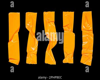 5 crumpled pieces of orange masking tape isolated on a black background Stock Photo