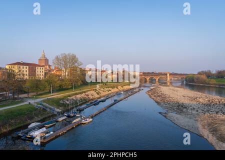 Skyline of Pavia , Ponte Coperto(covered bridge) is a bridge over the Ticino river in Pavia at sunny day, Pavia Cathedral background, Italy Stock Photo