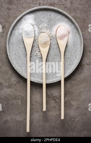Three types of sea salt in wooden spoons. Stock Photo
