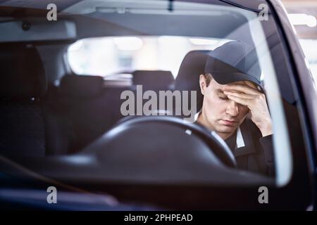 Sad man in car. Accident in traffic. Tired sleepy driver. Sick with headache or migraine. Anxiety, stress, despair or depression. Stock Photo