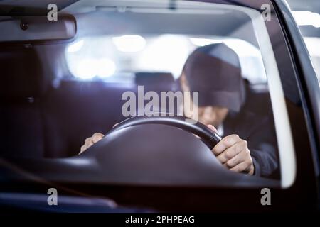 Tired and sleepy driver. Drowsy man driving car. Person sleeping in traffic. Accident or crash. Drunk person, alcohol law violation, DUI. Stock Photo