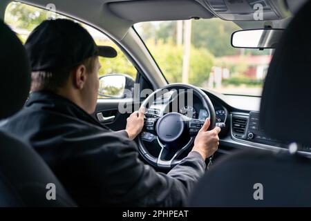 Driving car. Taxi cab driver or delivery professional. New vehicle buyer or owner on a test trip in summer. Dealership or rental business customer. Stock Photo