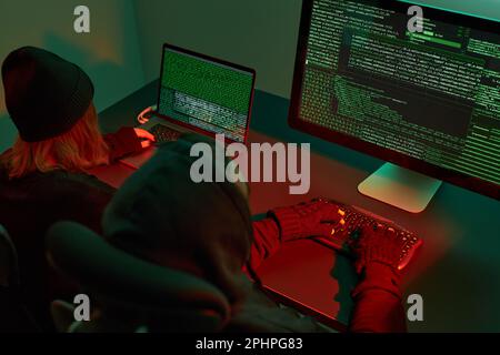 Anonymous people using computer and programming to break code. Cyber security threat. Internet and network security. Access to private information. An Stock Photo
