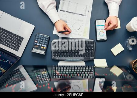 Businessman trading stocks online. Stock investor analysing numbers at graphs and screen. Investor planning and analysing stock market profiit. Man wo Stock Photo