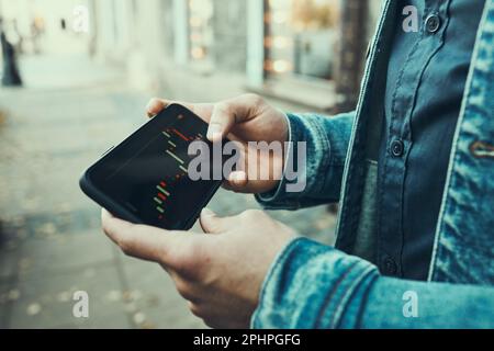 Person investing trading on stock cryptocurrency market using investing application on smartphone. Stock market investment in hand. Trader holding mob Stock Photo