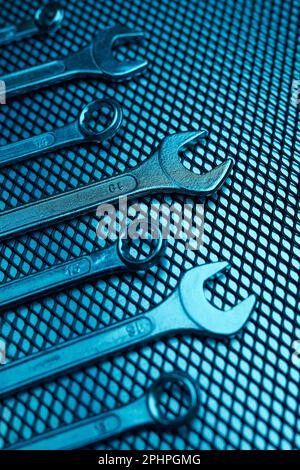 Set of chrome wrenches on steel surface. Mechanic tools for maintenance. Hardware tools to fix. Technical tools background with copy space Stock Photo
