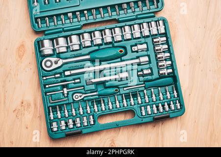 Ratchet with many attachments in plastic case. Work tools. Universal tool set. Background Stock Photo