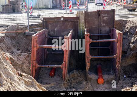 Replacement of underground communications with the using of sliding trench equipment to support the ground Stock Photo