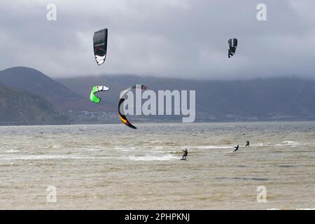 KItesurfers enjoy the thrills of surfing in wild and windy choppy seas off the West shore at Llandudno in the River Conwy estuary Stock Photo