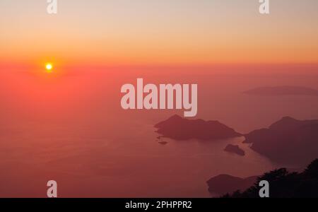 Summer scenery of Blue Lagoon with white sand located in city Oludeniz. Beautiful view on summer sea and town from top moutain. Sunset time Stock Photo