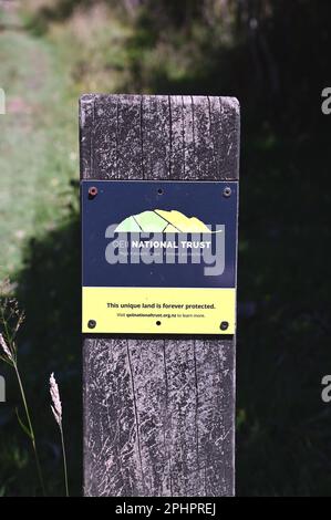 Sign post marking QE11National Trust covenanted land along the Queen Charlotte track in the Marlborough Sounds, South Island, New Zealand. Stock Photo