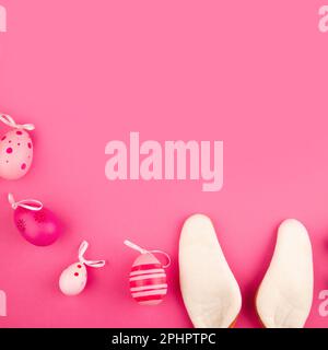 Pink Easter background with copy space, bunny ears and Easter eggs Stock Photo