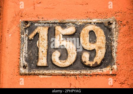 Old retro weathered cast iron plate with number 159 Stock Photo