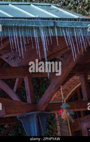 Icicles hanging from the roof. Stock Photo