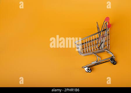 Shopping Basket on Yellow Background, Shopping Cart, Shop Cart Mockup, Empty Trolley, Supermarket Cart with Copy Space Stock Photo