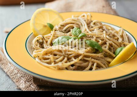 Spaghetti with a home made lemony kale and walnut pesto. Stock Photo
