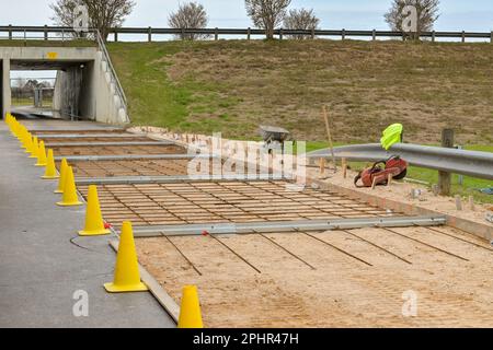 Houston, Texas, USA - February 2023: Steel reinforcing rods laid out on the foundation of a new road to reinforce the concrete Stock Photo