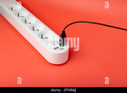 USB Plugs, Power Strip, Extension Cable, Electricity Strip USB Charging, Home Socket, Power Extender, Extension Cord on Pink Background with Copy Spac Stock Photo