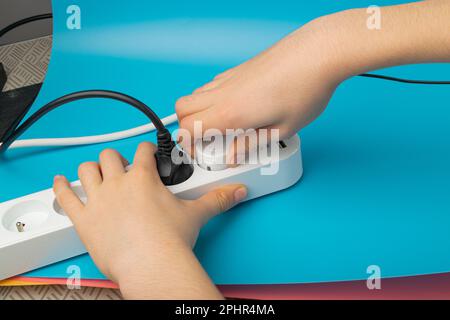 Plugging in Socket, Power Strip, Extension Cable, Electricity Strip USB Charging, Home Socket, Power Extender, Extension Cord on Blue Background Stock Photo