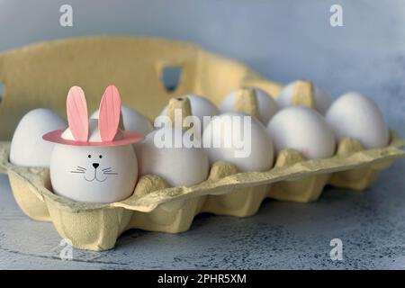 funny egg with bunny ears in tray Stock Photo