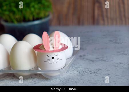 funny egg with bunny ears in tray Stock Photo