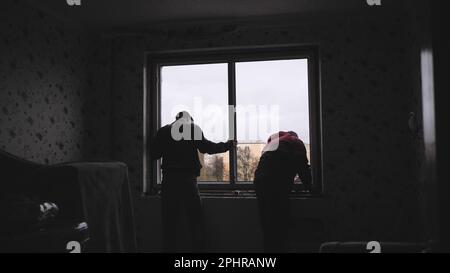 Silhouettes of workers installing new plastic windows. Stock Photo