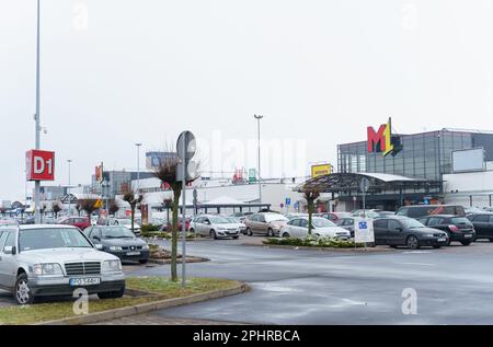 Poznan, Poland - January 25, 2023: Shopping center M1 near which customers' cars are parked. Stock Photo