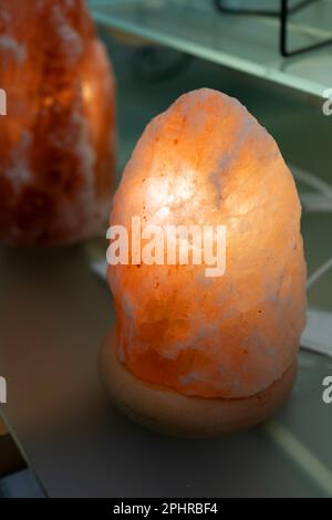 Himalayan Salt Lamp, Pink Salt Crystal Lantern, Glowing Salt Lamp with Healing Effect, Alternative Medicine Concept Stock Photo