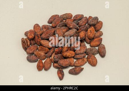 Organic raw cacao beans pile ready for roasting isolated on white background Stock Photo