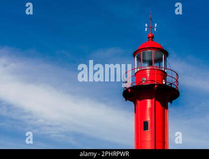 Red lighthouse against clear blue sky, close-up - horizontal Stock Photo
