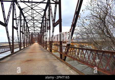 Grand Bridge over the Neosho (aka Grand) River at Fort Gibson, Oklahoma.  A train bridge that is still in use is visible in the background. Stock Photo