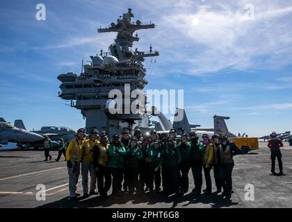 230328-N-EL850-1211 TYRRHENIAN SEA (March 28, 2023) Sailors assigned to the Nimitz-class aircraft carrier USS George H.W. Bush (CVN 77) pose for a photo after flight operations, March 28, 2023. The George H.W. Bush Carrier Strike Group is on a scheduled deployment in the U.S. Naval Forces Europe area of operations, employed by U.S. Sixth Fleet to defend U.S., allied and partner interests.(U.S. Navy photo by Mass Communication Specialist 3rd Class Nicholas Avis) Stock Photo