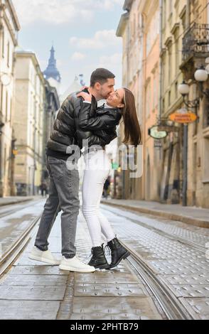 Lovely young couple walking together on city street. Romantic date Stock Photo