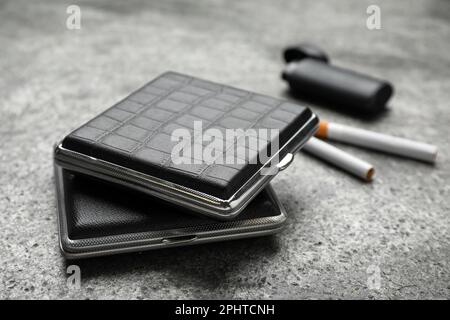 Closed leather cigarette cases on grey table, closeup Stock Photo