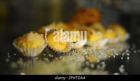 cupcakes lie on a dark glass table scattered with nuts delicious next to grains and walnuts. High quality photo Stock Photo