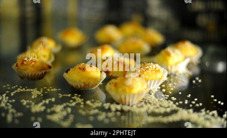 cupcakes lie on a dark glass table scattered with nuts delicious next to grains and walnuts. High quality photo Stock Photo