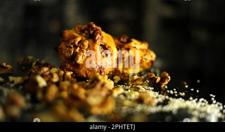 cupcakes lie on a dark glass table scattered with nuts delicious next to grains and walnuts. High quality photo Stock Photo