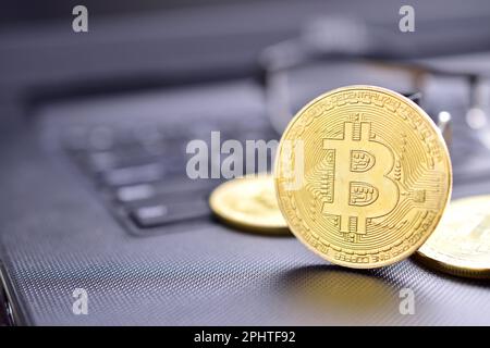 Closeup of bitcoin on computer table, cryptocurrency mining concept Stock Photo