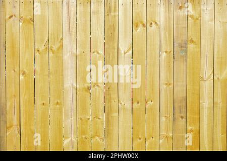 Bright natural yellow wood fence planks Stock Photo