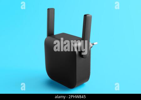 Black WiFi repeater on blue background Stock Photo
