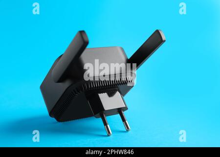 Black WiFi repeater on blue background Stock Photo