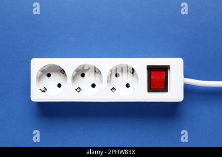Electric extension cord on blue background Stock Photo
