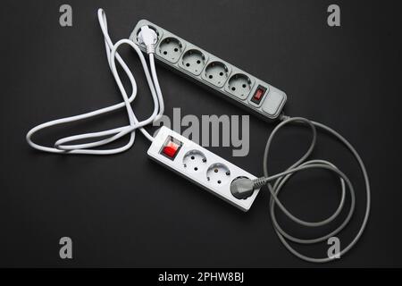 Electric extension cords on black background Stock Photo