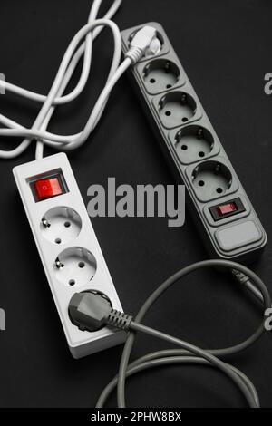 Electric extension cords on black background Stock Photo