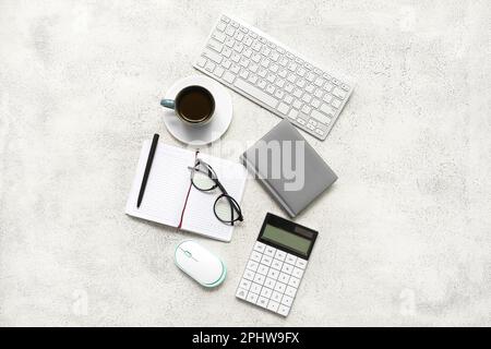 Composition with eyeglasses, blank notepad and coffee on light grunge background Stock Photo