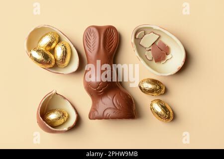 Chocolate Easter eggs and bunny on beige background Stock Photo