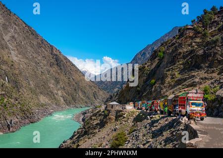 landscape of snow mountains and road with colorful trucks , beautiful decorated Pakistani trucks on the Karakorum highway in gilgit baltistan Stock Photo