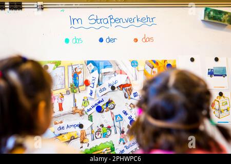 Hanover, Germany. 23rd Mar, 2023. A child from Ukraine and a child from Russia take part in German lessons at the Comenius School while looking at a display board. The number of Ukrainian students in Lower Saxony has recently increased again. According to the Ministry of Education in Hanover, 20,810 children and young people from Ukraine are currently being taught statewide (as of March 15, 2023), a good six percent more than a month earlier (to dpa 'Number of Ukrainian students up again') Credit: Moritz Frankenberg/dpa/Alamy Live News Stock Photo