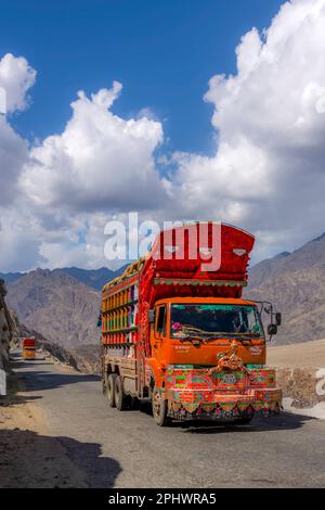 Orange coloured lorry truck driver in chassis cab with tanker body for ...